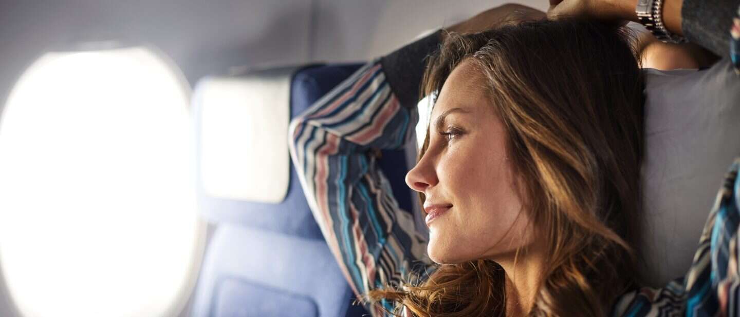 Passenger looking out of an aircraft window